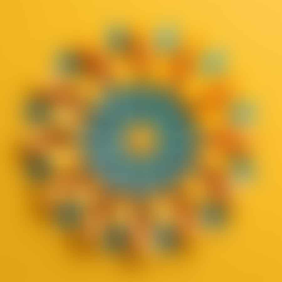 Quilled petals being arranged around a yellow center